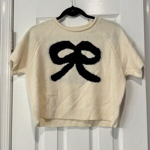 Cream Sweater with Black Bow Design